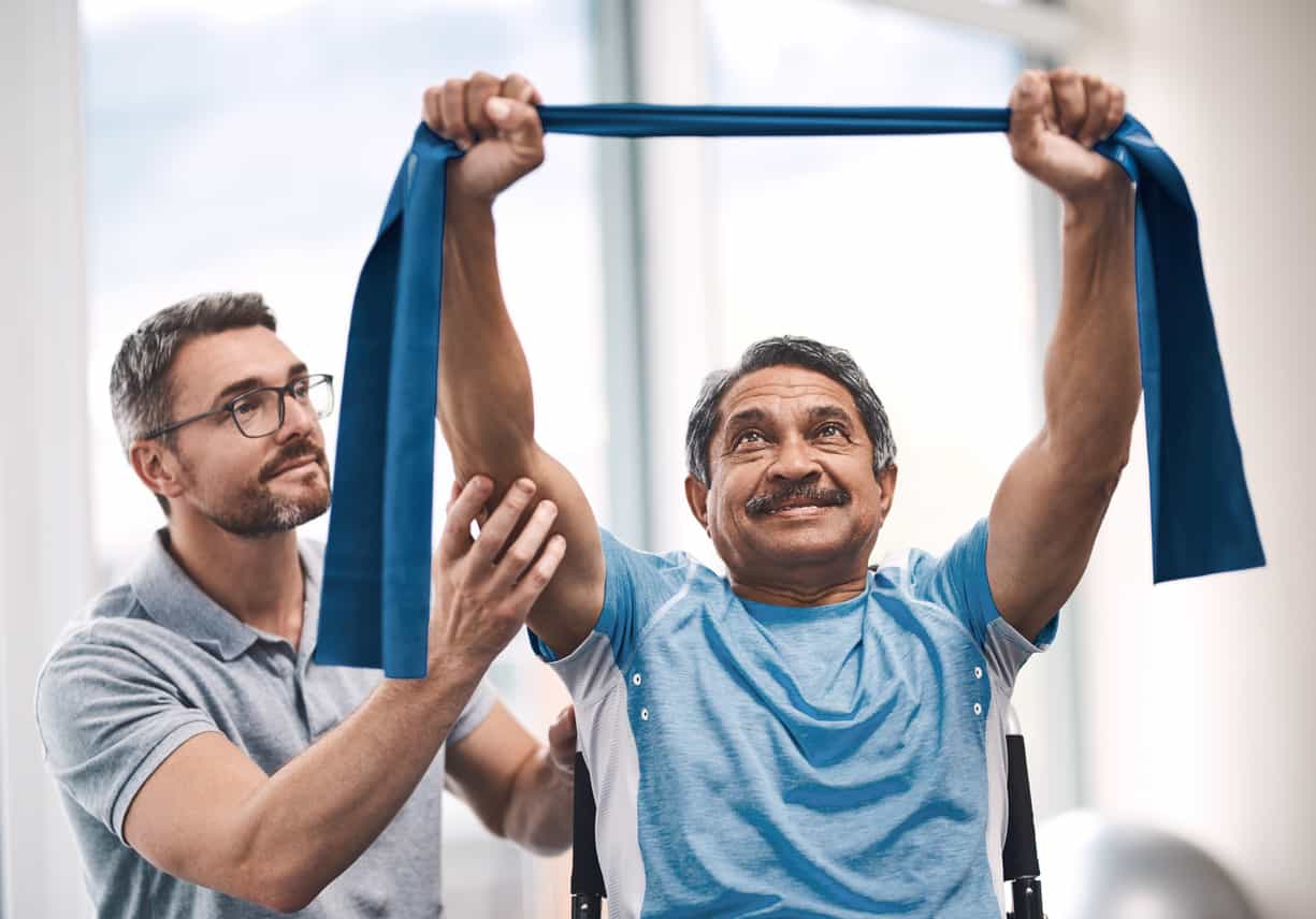Shot of a senior man exercising with a resistance band during a rehabilitation session with his physiotherapist